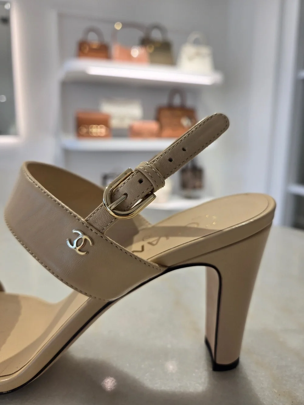 CHANEL Beige Slingback Heels with Black-and-Gold Chain